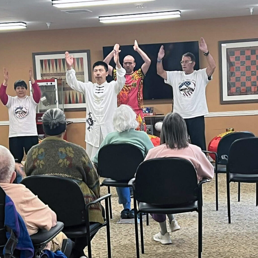 Residents watch an engaging presentation during an event at Carriage Court.